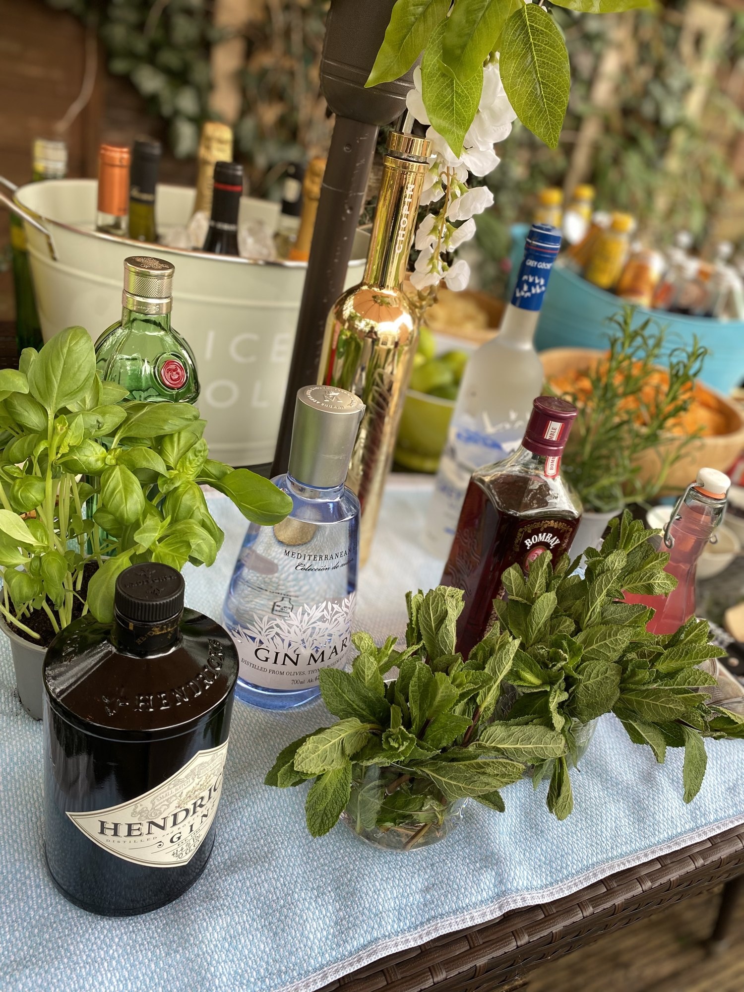 Spirits and fresh herbs arranged on an event bar.