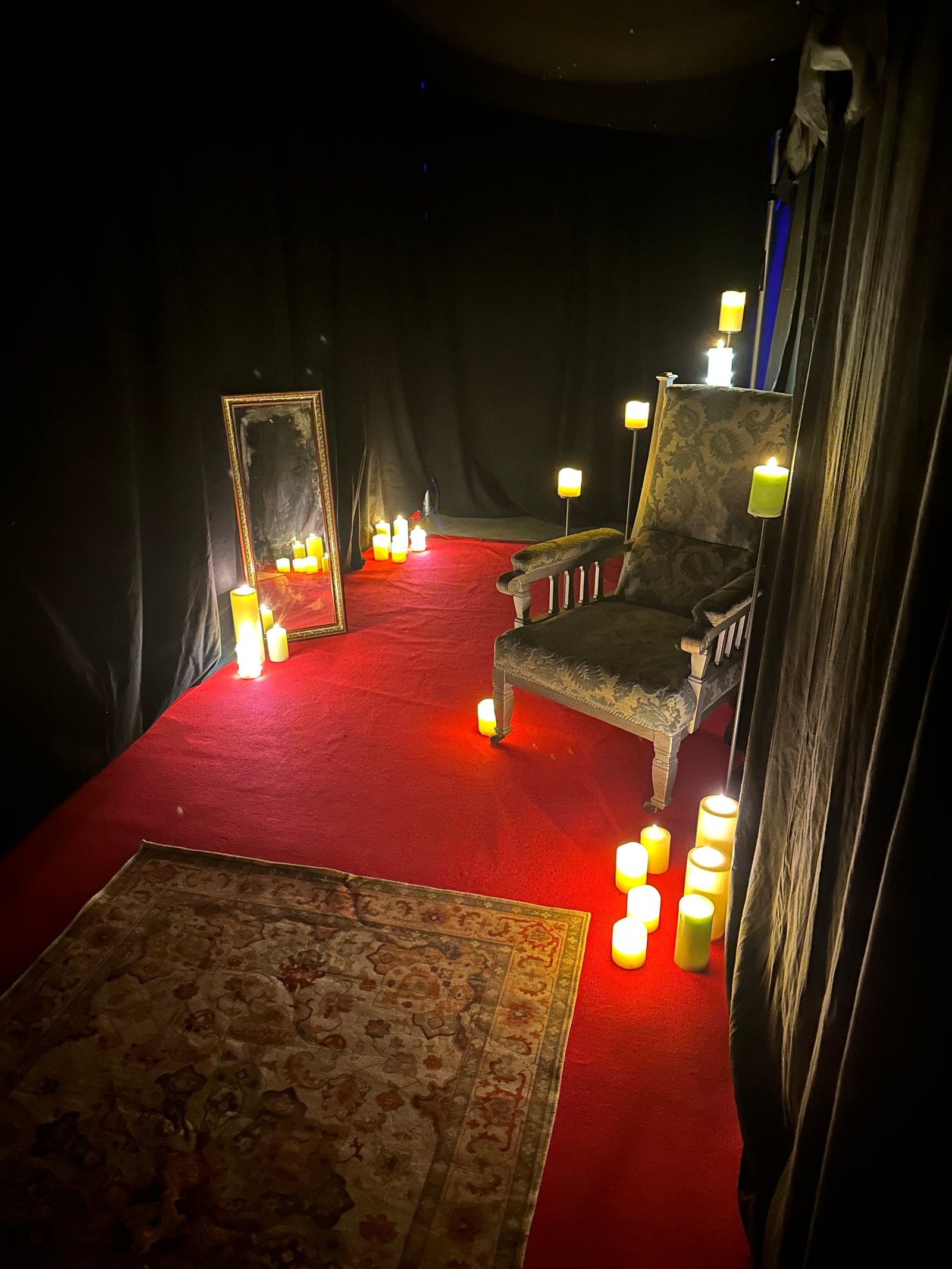 Candlelit haunted-house room created inside the supplied marquee